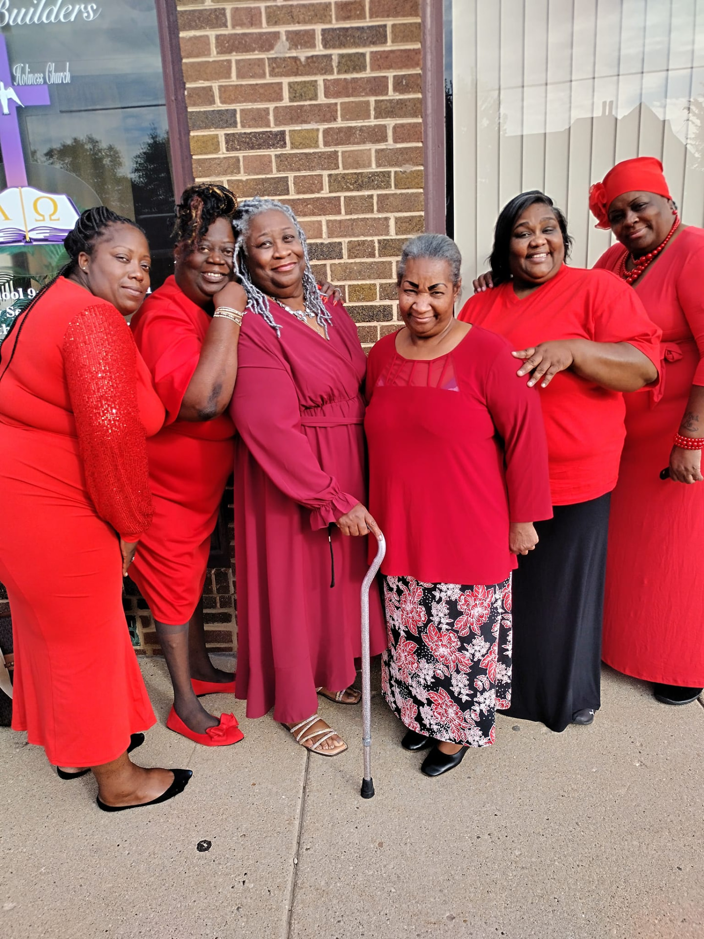 A group of women standing together outside a church